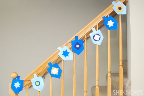 Creating a dreidel garland with felt or paper is a craft that can also serve as a decoration. 