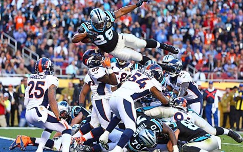Jonathan Stewart jumps over the pile to score a touchdown and make the score 10-7.