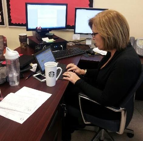 Mrs. Suarez enjoys a cup of Starbucks coffee while working hard.