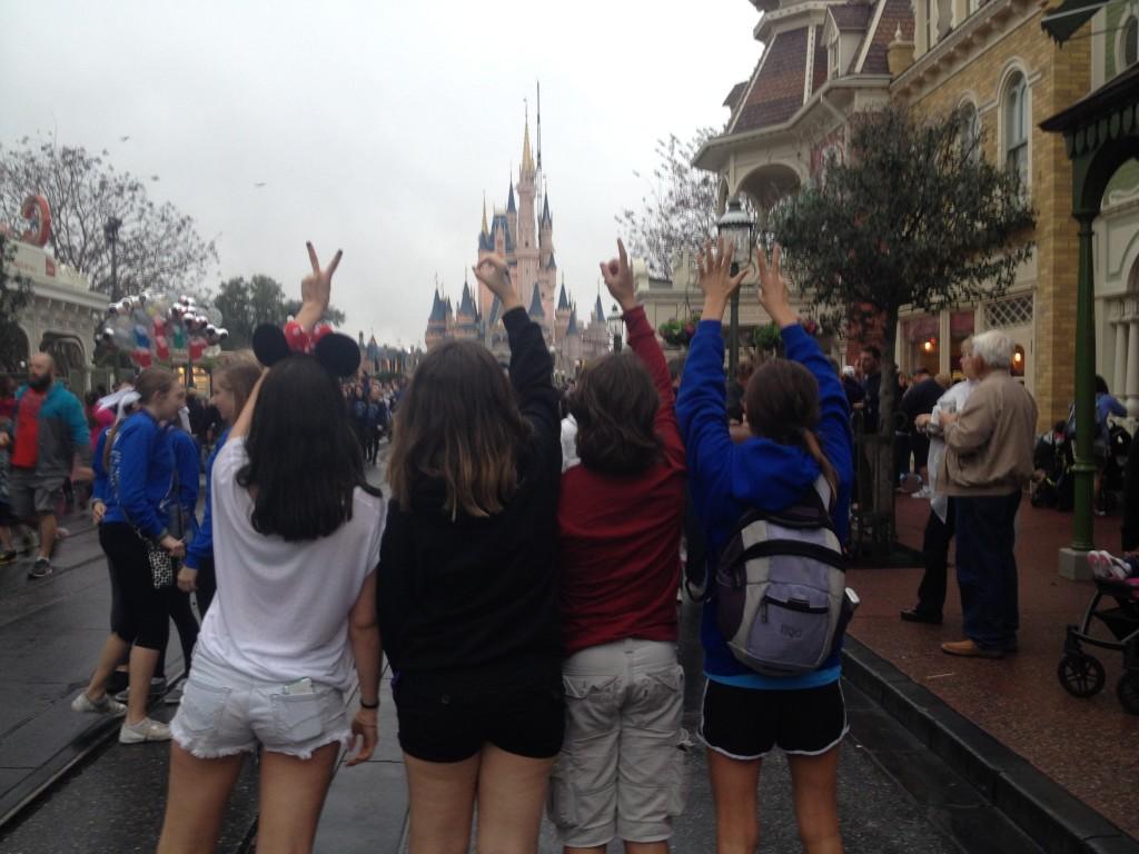Freshman Hannah Cordes (right), Michael Moreno (2nd to the right), Natalia Clement (2nd to the left), and Amanda Lopez (left) pose in front of Magic Kingdom's Castle.