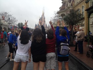 Freshman Hannah Cordes (right), Michael Moreno (2nd to the right), Natalia Clement (2nd to the left), and Amanda Lopez (left) pose in front of Magic Kingdom's Castle.