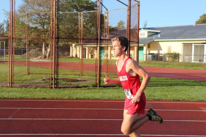 One of the cross country team members running on the track