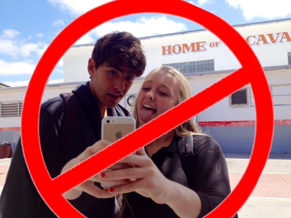 Freshman Cassidy Wall and senior Christian Diaz take countless selfies, behavior that Britain announced on April Fools Day it was banning. 