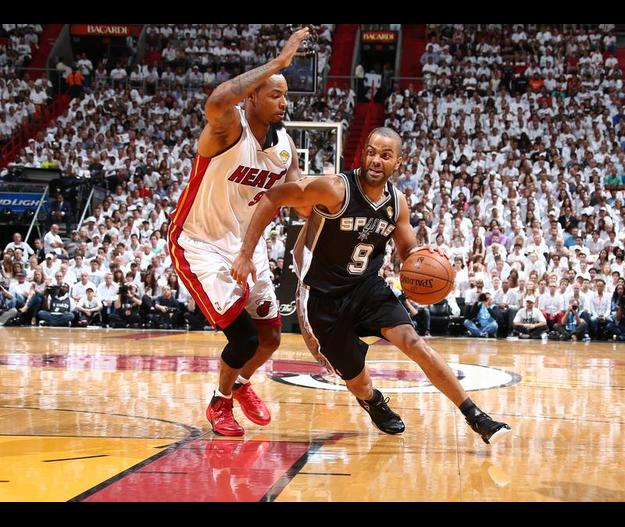 As Parker drives to the basket, Lewis attempts to block his shot.