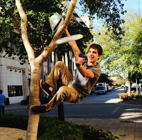 Rafael Gonzalez combining his love of frisbee with his love of climbing and parkour at Merrick Park.