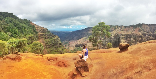 Claire resting while hiking at Waimea Canyon, Kauai, Hawaii. This site is known as the Grand Canyon of Hawaii.