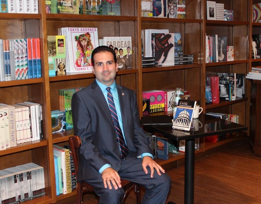 Daniel Pedreira proudly sits with his acclaimed book.