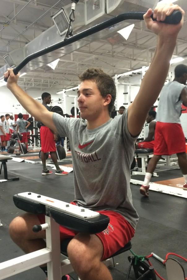 John Smithies, IB sophomore and dedicated JV football linebacker, works hard in the weight room.