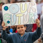 A young boy takes a stand at the Climate March. 