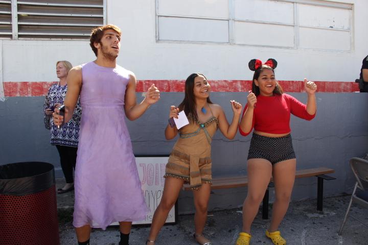 Members of Gables Players dance to the music performed by the Band of Distinction to draw attention to their club. 