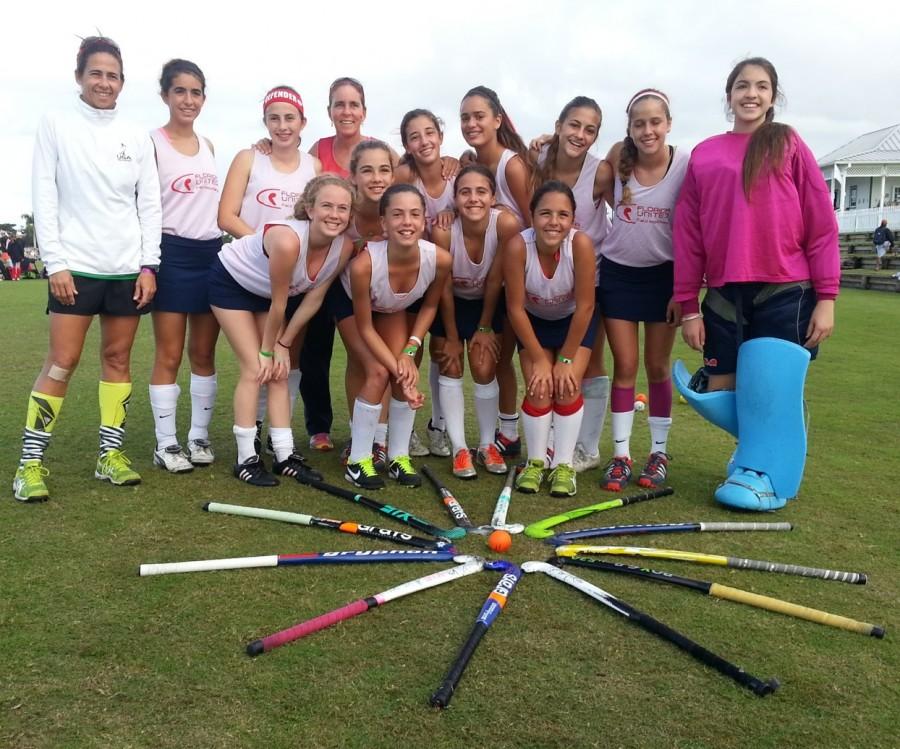 Julene Valmaña (left, front row) poses with her field hockey team, Florida United.