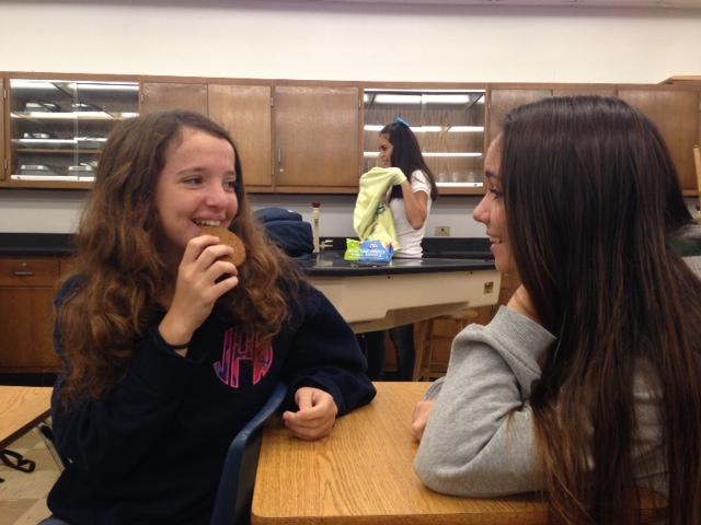 Sophomores Amanda Hopkins and Arden Avera share a laugh as they eat a ginger snap cookie.