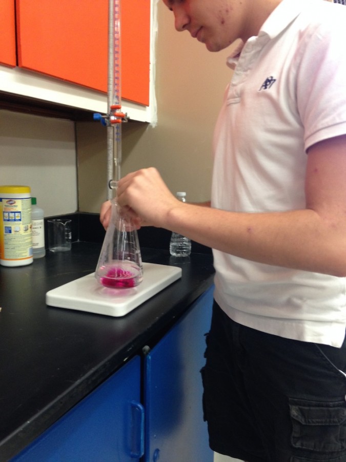 Junior Kevin Torgas explores his love for Chemistry while performing an experiment.