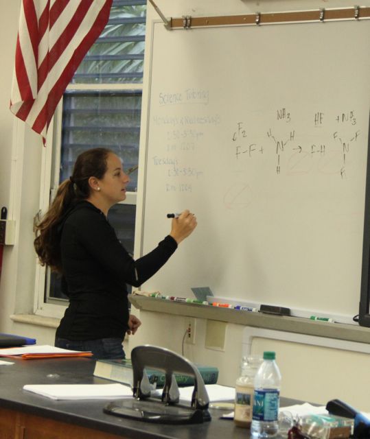 Ms. Fraga displays a Chemistry equation on the board for her students.