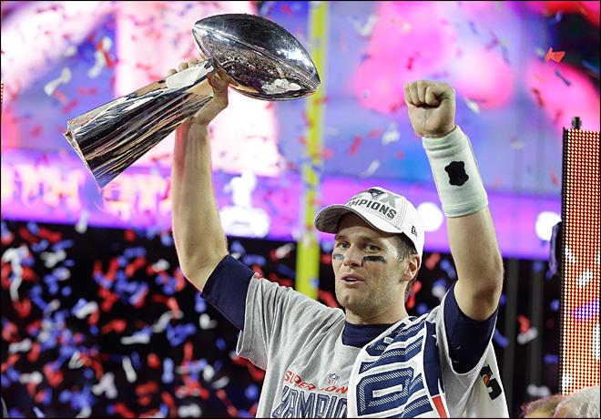 The New England Patriots quarterback Tom Brady lifting the Super Bowl trophy after their 28-24 victory over The Seattle Seahawks.