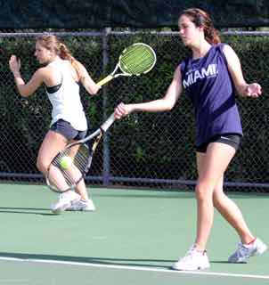 Junior Raphaela Game and Senior Alexa Alcalay warming up before their match.