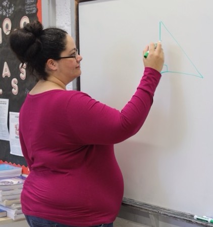 Mrs. Reinoso teaching her geometry students about triangles.