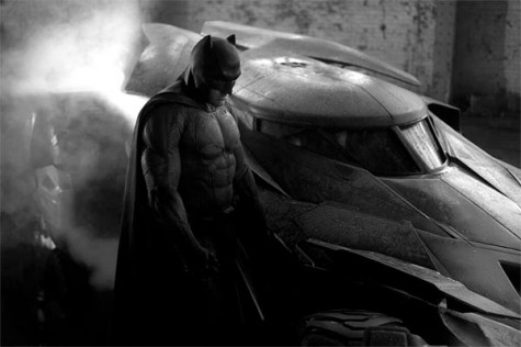 Batman being shown in the new Bat suit standing next to the New Bat-mobile. (Lots of Bats)