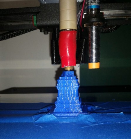 The 3D printer beginning to make a miniature Statue of Liberty.