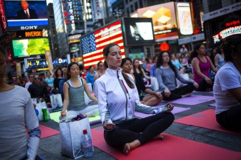 People gather in Times Square to practice Yoga during the Summer Solstice