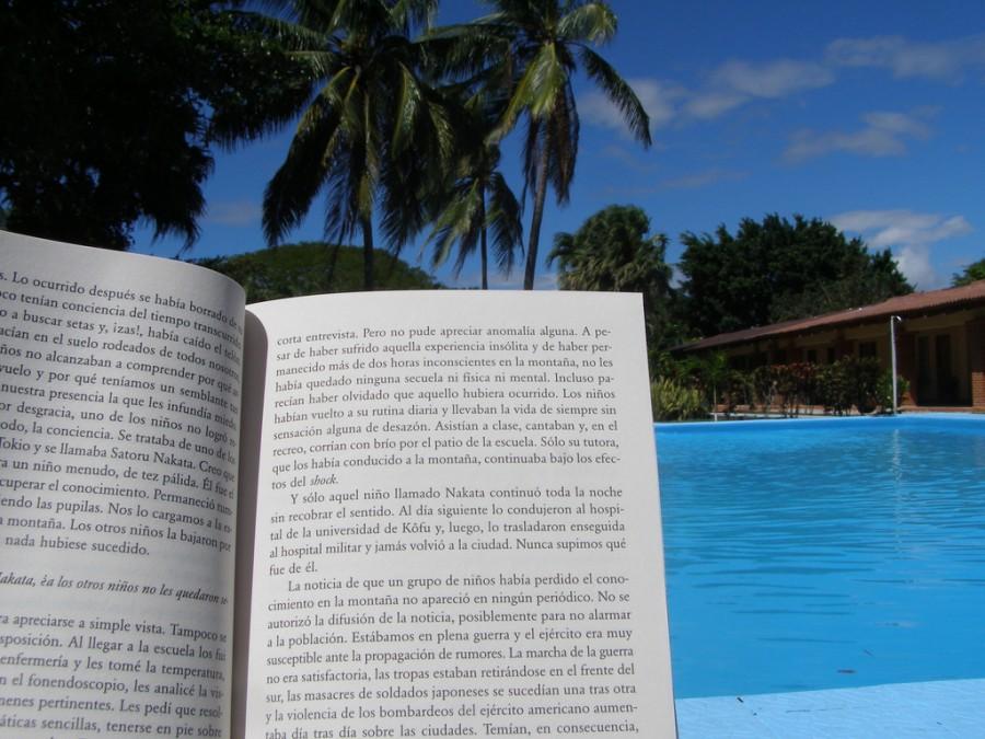 A slightly educational summer- finishing up summer reading by the pool.