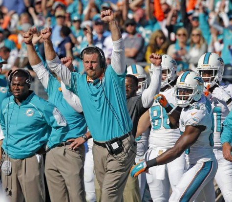 The Dolphins Interim coach celebrating his team scoring a touchdown to further seal the lead.