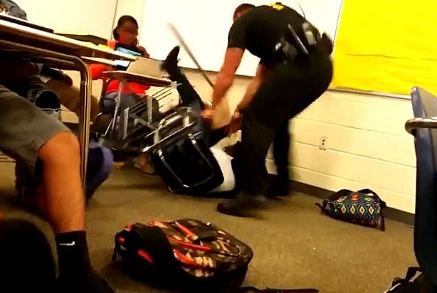 Its hard to believe that an officer would be so aggressive to a student sitting at her desk.