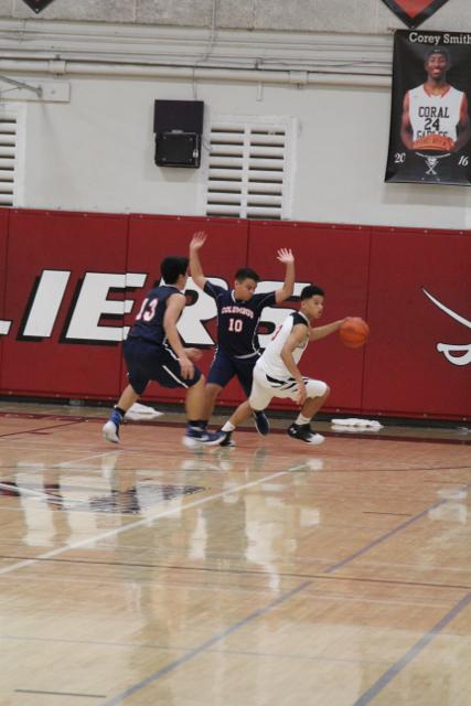 Cavs Beat Out Explorers in Varsity Basketball