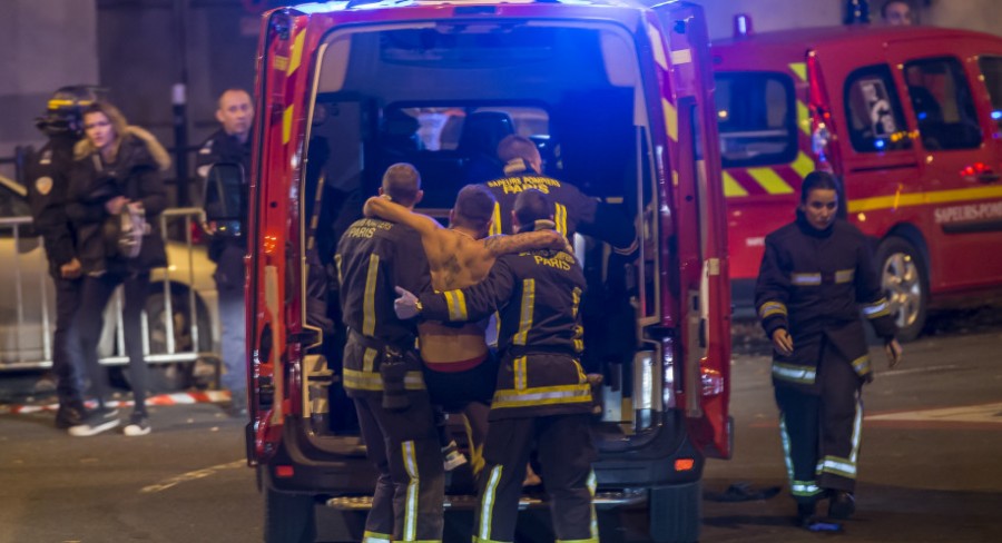 Rescue personnel work together in giving survivors medical treatment.