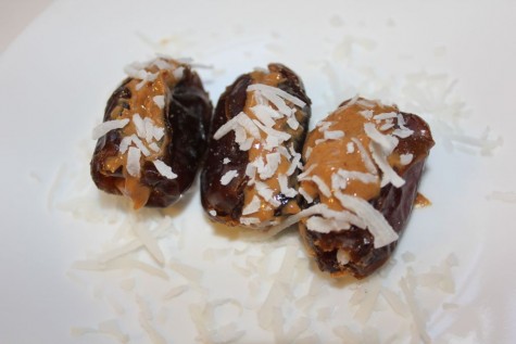 Medjool Dates filled with peanut butter and sprinkled with unsweetened Coconut Flakes.