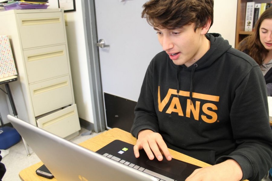 Junior George Poincot creates a new website on his computer.