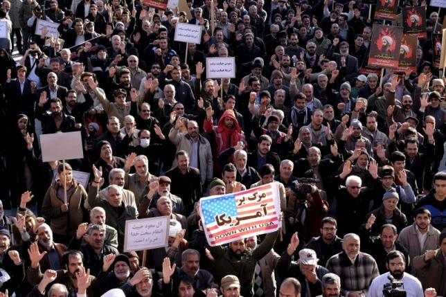 People protesting with slogans during a presentation against the execution of Sheikh Nimr al-Nimr in Saudi Arabia.