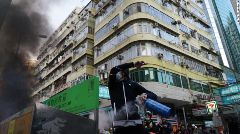 The effect explosions had on local shops and a masked protester carrying a canister.