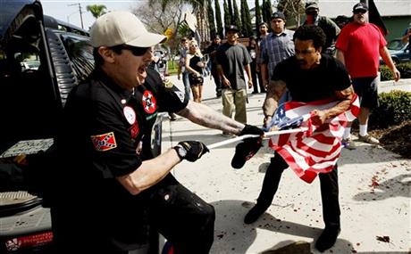 The use of the flag pole as a weapon in seen in this picture from the recent rally the KKK had.