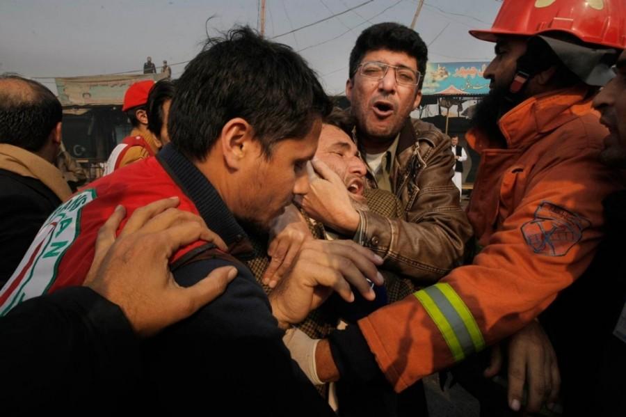 Rescue officials giving aide to the victims of the suicide bombing in an amusement park of Lashore. Pakistan. 