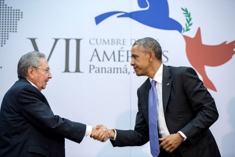 President Obama shakes hands as he speaks with President Castro about making amends