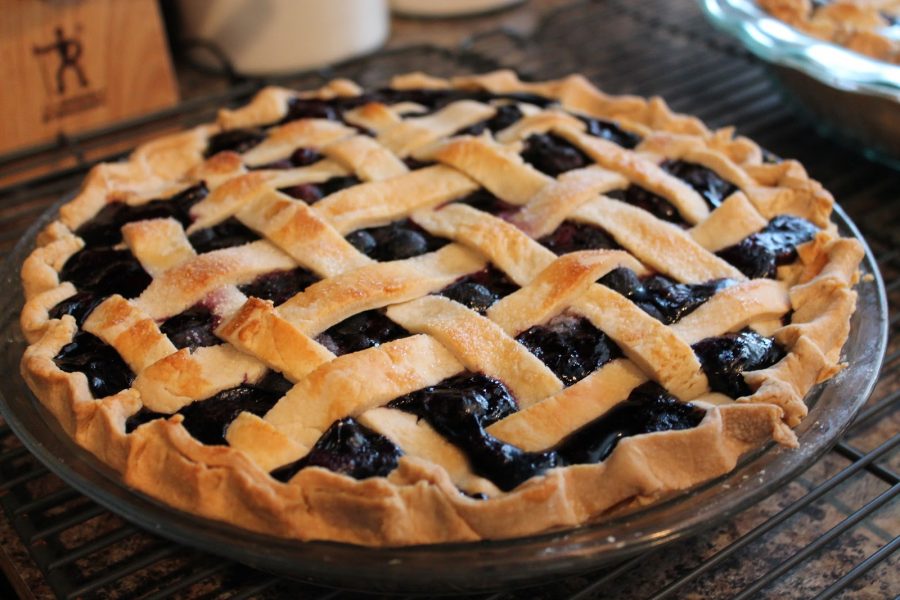 Visual of a blueberry pie celebrating National Blueberry Pie Day.