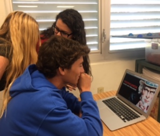 Seniors Ari Alcalay, Julene Valmana and Deylis Perez discuss propaganda in class. 