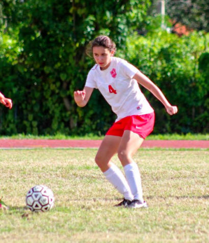 Amy Ransom races to retrieve the ball before her opponent. 