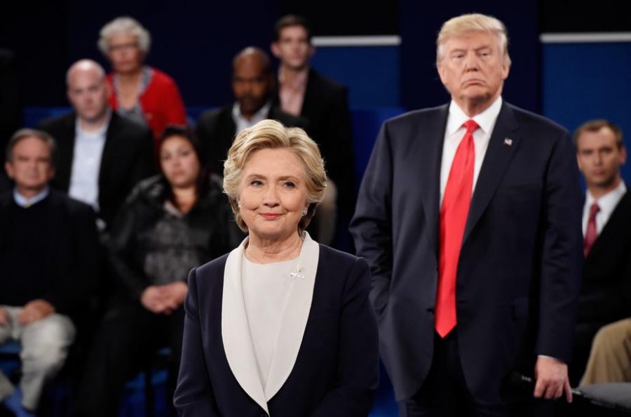 Former Secretary of State Hillary Clinton and Republican presidential nominee Donald Trump listen during the town hall debate in Missouri.