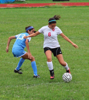 Amy kicking the ball upfield.