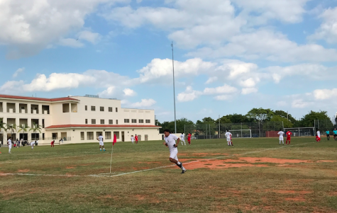 Both boys teams set up for a goal kick during the match.