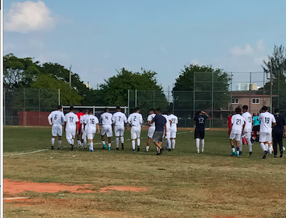 The boys teams take the field, anxious to begin the game.