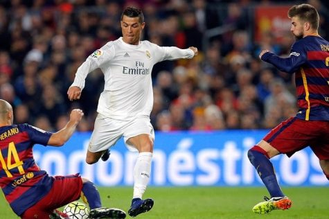 Mascherano and Pique attempt to stop Cristiano Ronaldo. He himself is trying to get rid of the ball