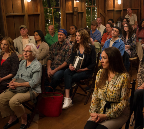 Lorelai and Luke enjoy the Stars Hollow town meeting.