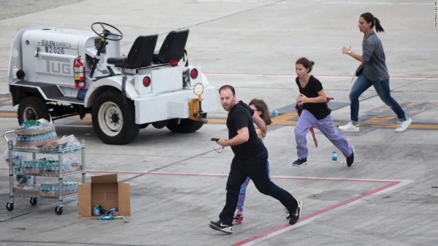 People at the Fort Lauderdale Airport flee from the shooting.