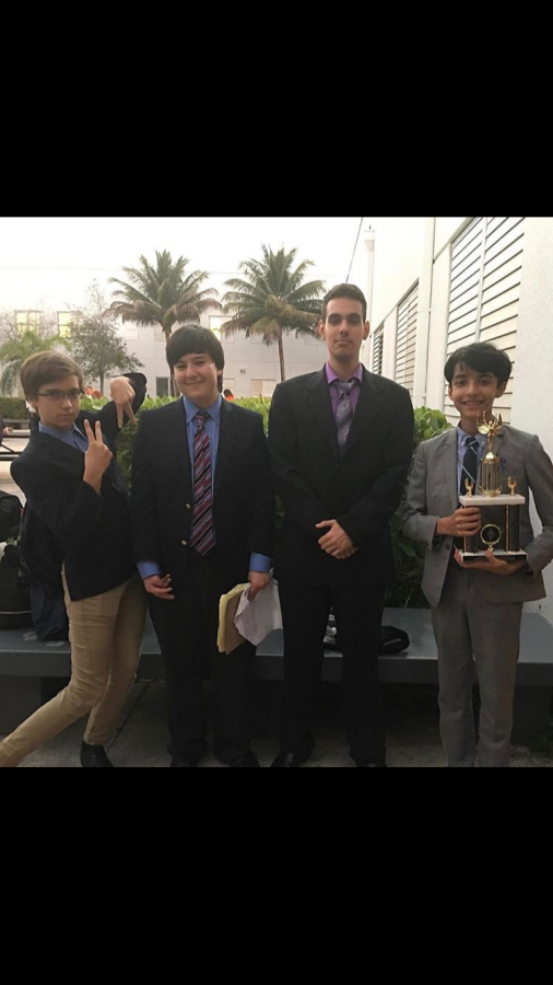 The team poses for a photo after the debates.