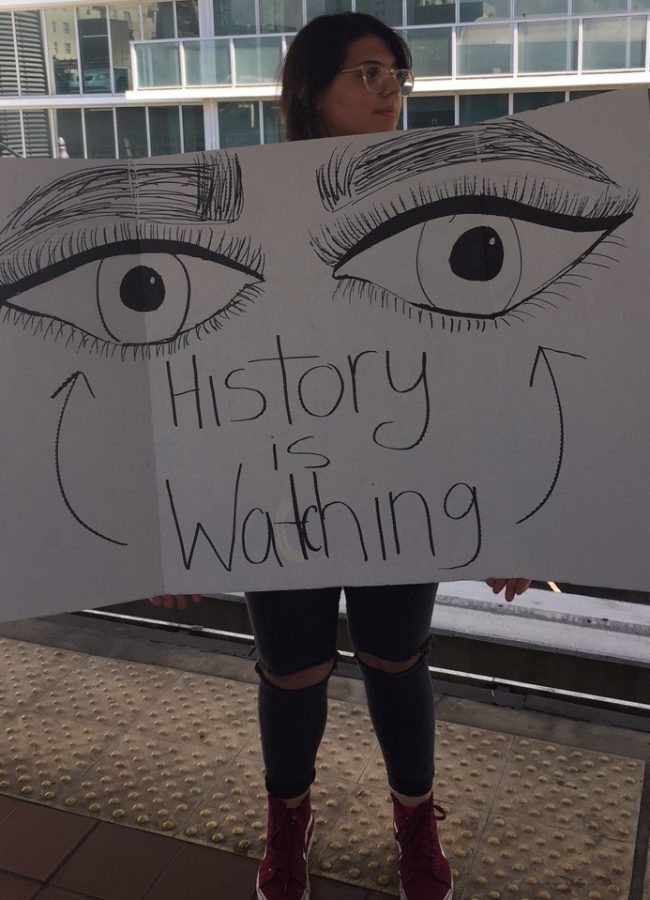 Senior Bianca Pasci posed with her creative sign expressing her anger toward Trump's Muslim ban.
