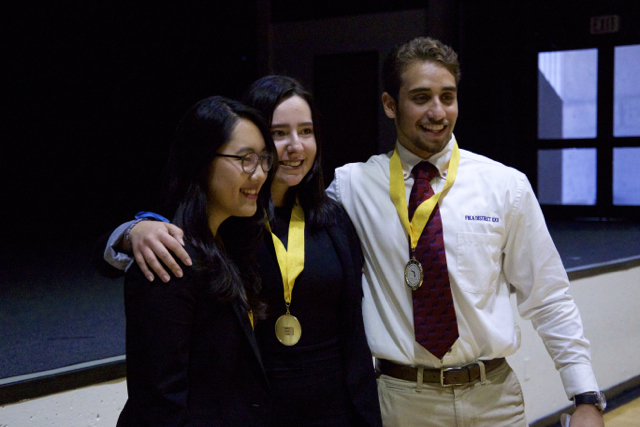 Marketing team receives first place medals (Maria Ordonez, Shawn Torres, Sunny Na).