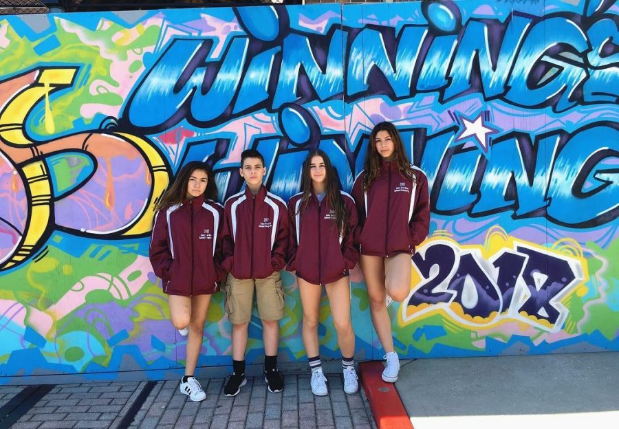 Team members, Marisol, Chris, Alessia, and Ariadna, posing for a picture at Universal after crushing the competition. 